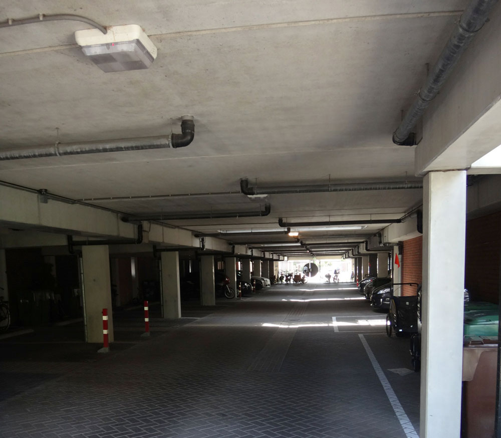 The garages underneath the homes. The length of each block of homes is determined by the maximum length over which it is possible to naturally ventilate the car park underneath, avoiding costly mechanical ventilation systems